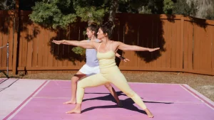 two women performing somatic exercises.