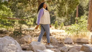 woman using a walking workout plan, during nature walk.