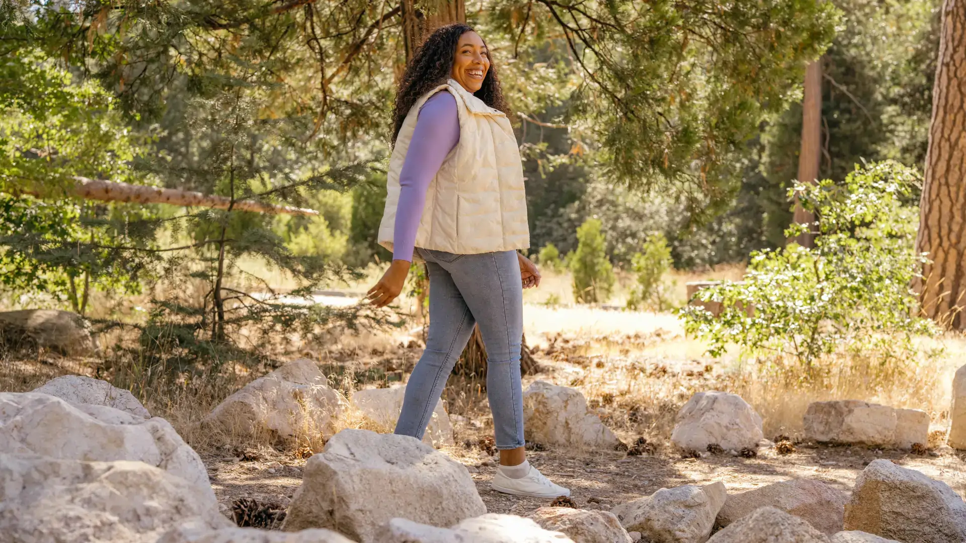 woman using a walking workout plan, during nature walk.