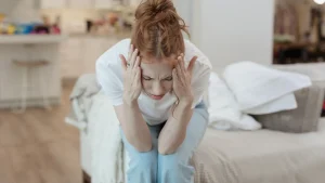woman with hands on her head clearly stressed from decision fatigue.
