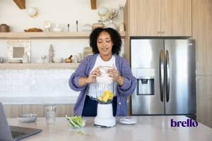 woman making a protein shake in kitchen, from how much protein should I eat on GLP-1 article.