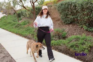 woman walking her dog, example of how to increase energy levels naturally.