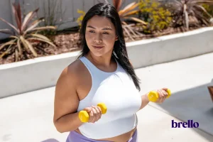 woman holding small dumbbells practicing low impact strength training.