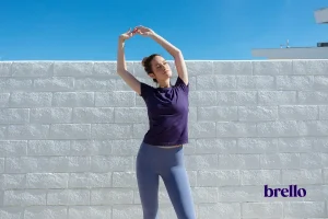 Woman posing for Wall Pilates for Beginners.
