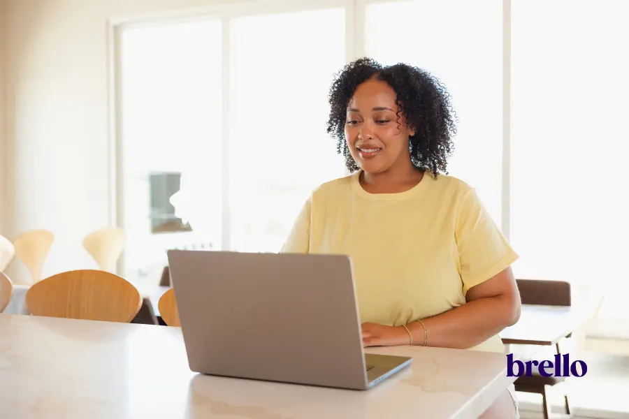 woman in the kitchen using laptop representing how to choose a glp-1 program.