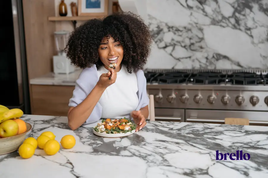 Woman eating chicken salad, example of GLP-1 lunch ideas.
