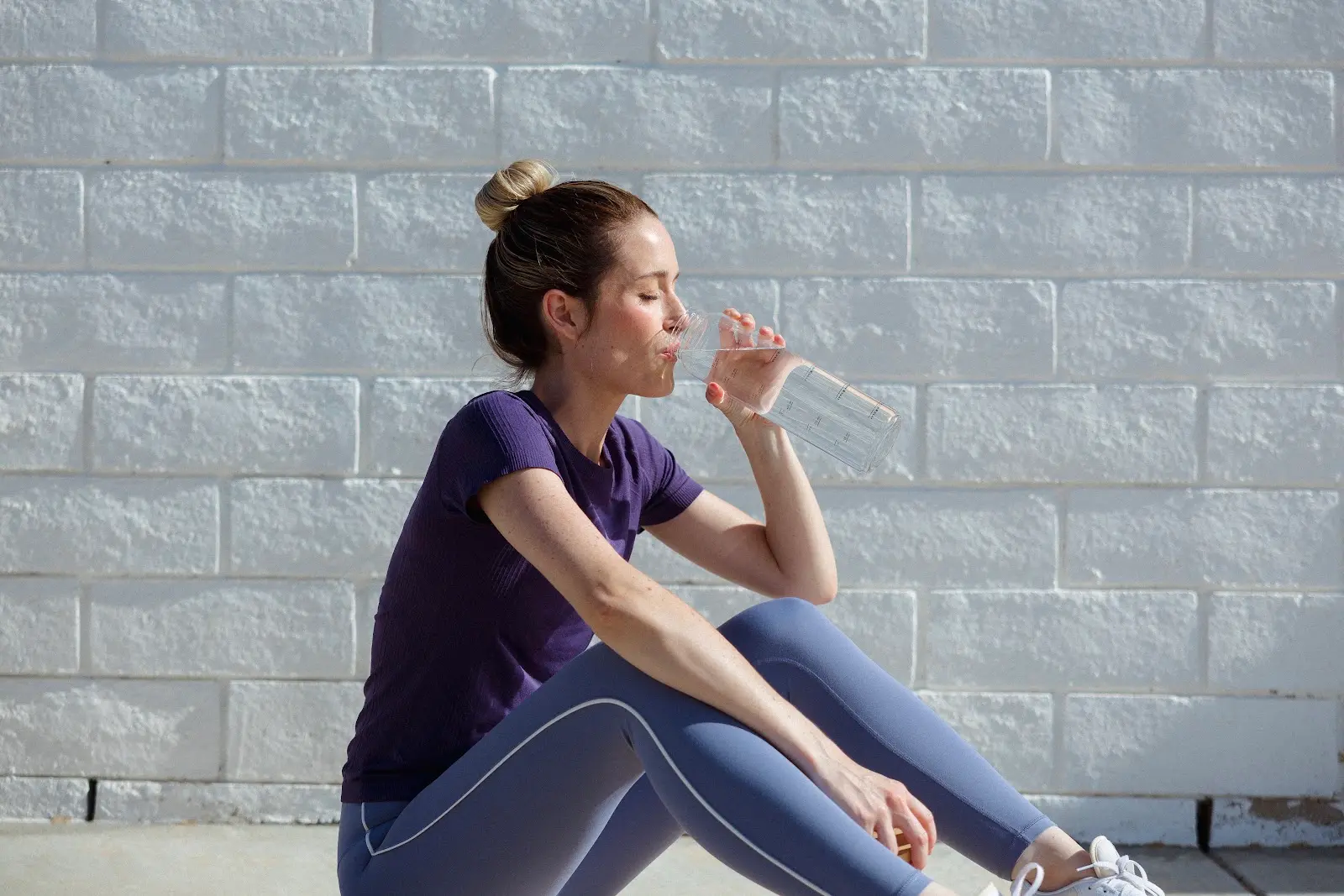 Active woman reaching for the best electrolytes for hydration during workout